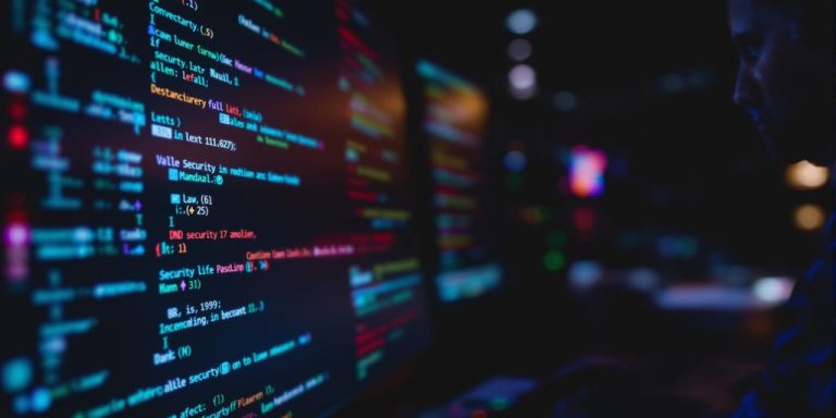 Person analyzing cybersecurity alerts on a computer screen.